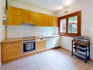 This charming kitchen features warm wooden cabinetry and a bright, inviting atmosphere.