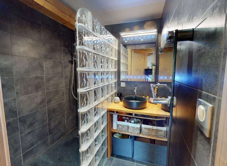 Step into this modern bathroom featuring a unique glass block shower enclosure.