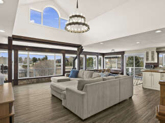 This stunning property boasts a spacious living area with high ceilings and abundant natural light, perfect for entertaining or relaxing.