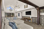Step into luxury with this stunning living room, boasting a spacious layout and high ceilings.