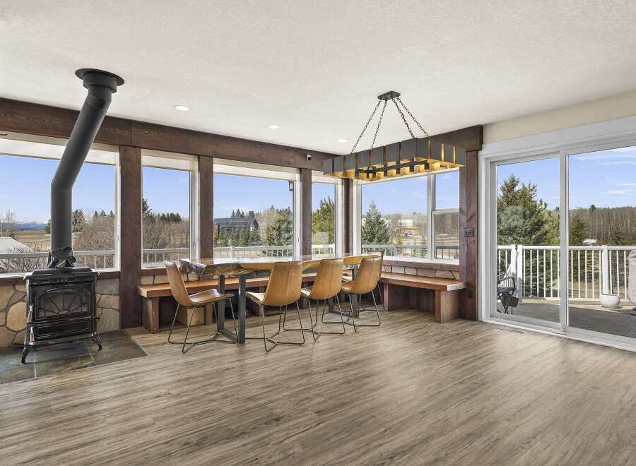 This stunning property boasts a spacious dining area with a unique live-edge table and stylish seating, perfect for entertaining.