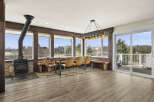 This stunning property boasts a spacious dining area with a unique live-edge table and stylish seating, perfect for entertaining.