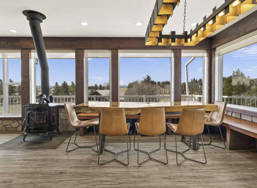 This stunning dining area features a unique live-edge wooden table, perfect for gatherings.