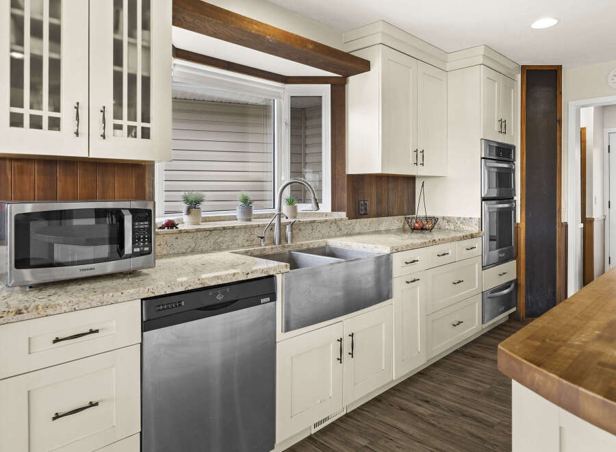 This stunning kitchen boasts a modern design with stainless steel appliances and elegant white cabinetry.