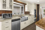 This stunning kitchen boasts a modern design with stainless steel appliances and elegant white cabinetry.