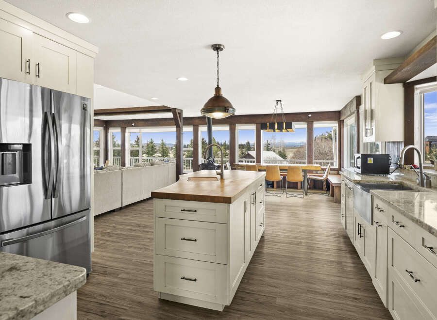 This stunning kitchen boasts a spacious layout with a large island, perfect for meal prep and entertaining.