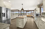 This stunning kitchen boasts a spacious layout with a large island, perfect for meal prep and entertaining.