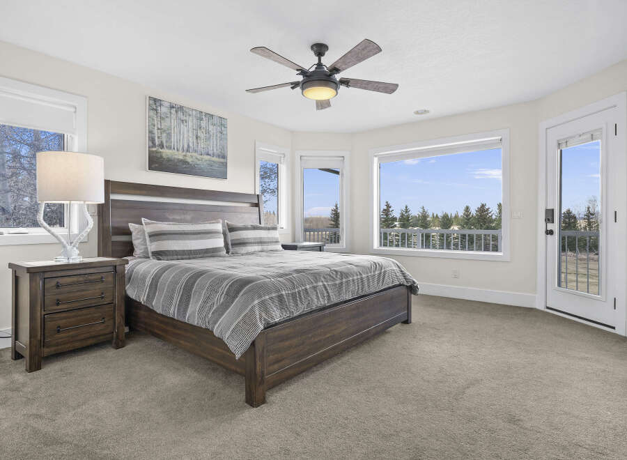 This stunning bedroom offers a serene retreat with its spacious layout and abundant natural light.