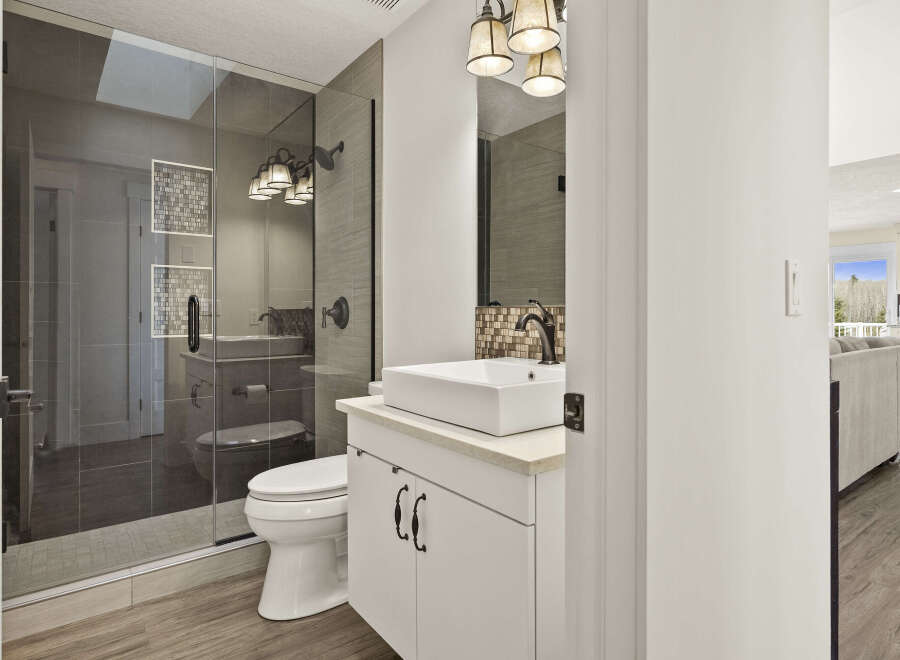 Step into luxury with this beautifully designed bathroom! Featuring a sleek, modern vanity with a vessel sink, and a spacious glass-enclosed shower, this space is both stylish and functional.