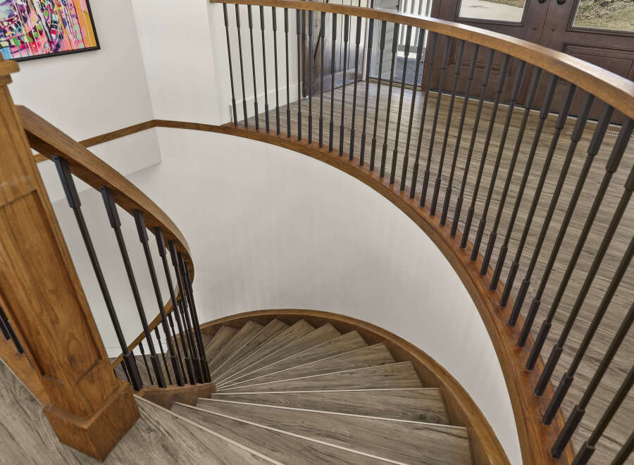 This stunning property boasts a beautifully crafted spiral staircase, a true architectural highlight.