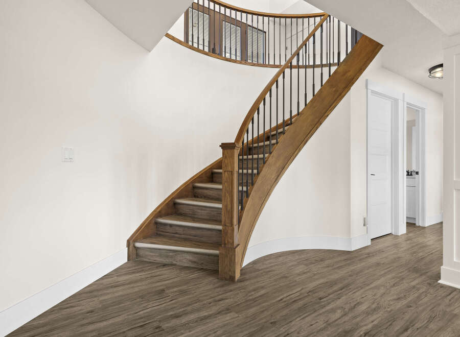 This stunning property features a beautifully crafted staircase with wooden accents, adding a touch of elegance to the interior.