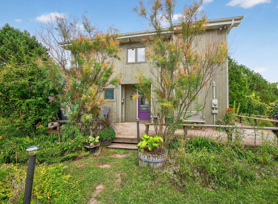 Discover this charming property featuring a unique exterior design and a welcoming front porch.