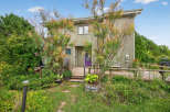 Discover this charming property featuring a unique exterior design and a welcoming front porch.