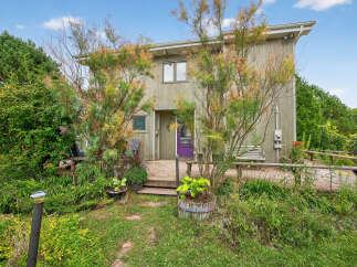Discover this charming property featuring a unique exterior design and a welcoming front porch.