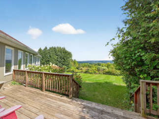 Enjoy breathtaking views from this stunning property! This home features a spacious deck, perfect for outdoor entertaining and relaxation.