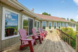 Enjoy the serene beauty of this stunning property featuring a spacious deck perfect for relaxation and entertaining.