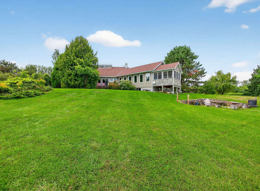 This stunning property boasts a spacious, well-manicured lawn, perfect for outdoor activities and relaxation.