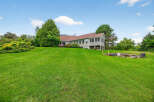 This stunning property boasts a spacious, well-manicured lawn, perfect for outdoor activities and relaxation.