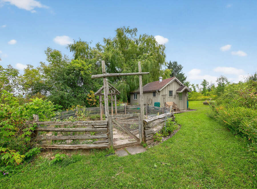 Discover a charming property with a rustic garden and a cozy shed, perfect for those seeking a tranquil retreat.