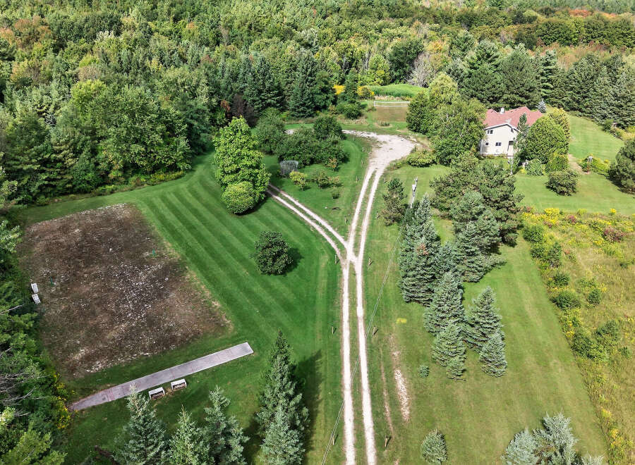 Discover a stunning property nestled in a serene, wooded landscape.