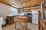 This charming kitchen boasts a rustic aesthetic with its wooden cabinetry and butcher block island.