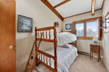 This charming bedroom features a cozy bunk bed, perfect for a vacation home or a kid's room.