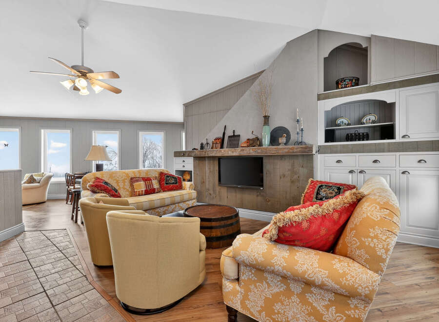 This inviting living space features a cozy seating area with a stylish sofa and armchairs, perfect for relaxation.