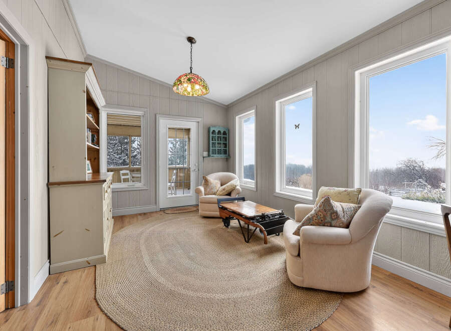 Step into this inviting living space, featuring a cozy seating area and a charming, rustic aesthetic.