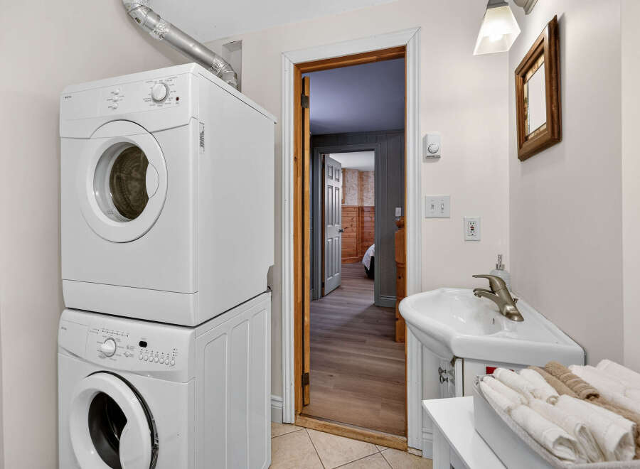 Discover the convenience of this well-appointed laundry room, featuring a modern stacked washer and dryer.