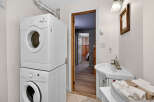 Discover the convenience of this well-appointed laundry room, featuring a modern stacked washer and dryer.