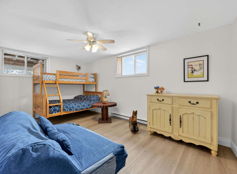 This charming bedroom features a cozy bunk bed, perfect for kids or guests.