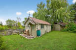 Charming countryside retreat! This property features a quaint shed with a rustic design, perfect for storage or a workshop.