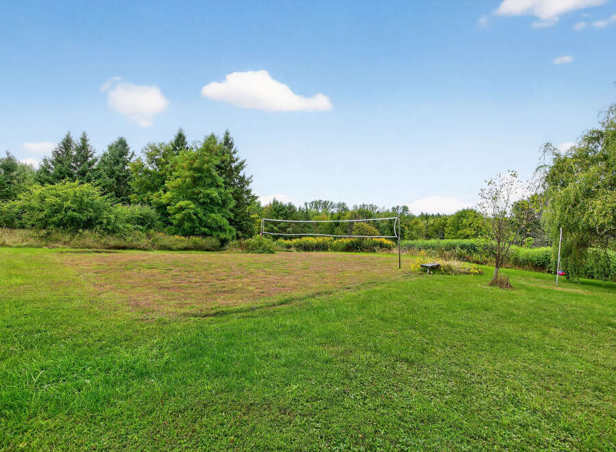 Enjoy outdoor activities in this spacious yard! This property features a volleyball net, perfect for friendly matches and summer fun.