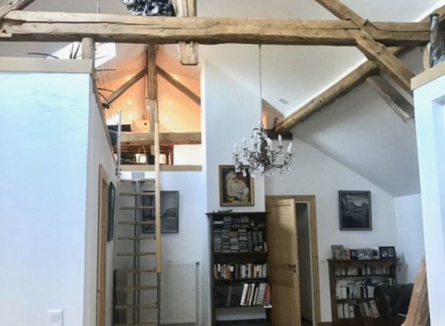 This stunning property boasts a unique open-plan living area with exposed wooden beams and a charming mezzanine level.