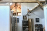 This stunning property boasts a unique open-plan living area with exposed wooden beams and a charming mezzanine level.