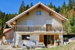 Charming chalet nestled in the French Alps, boasting a spacious balcony with mountain views and a private patio perfect for outdoor relaxation.