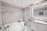 This stunning bathroom features a luxurious jacuzzi tub, perfect for relaxing after a long day.