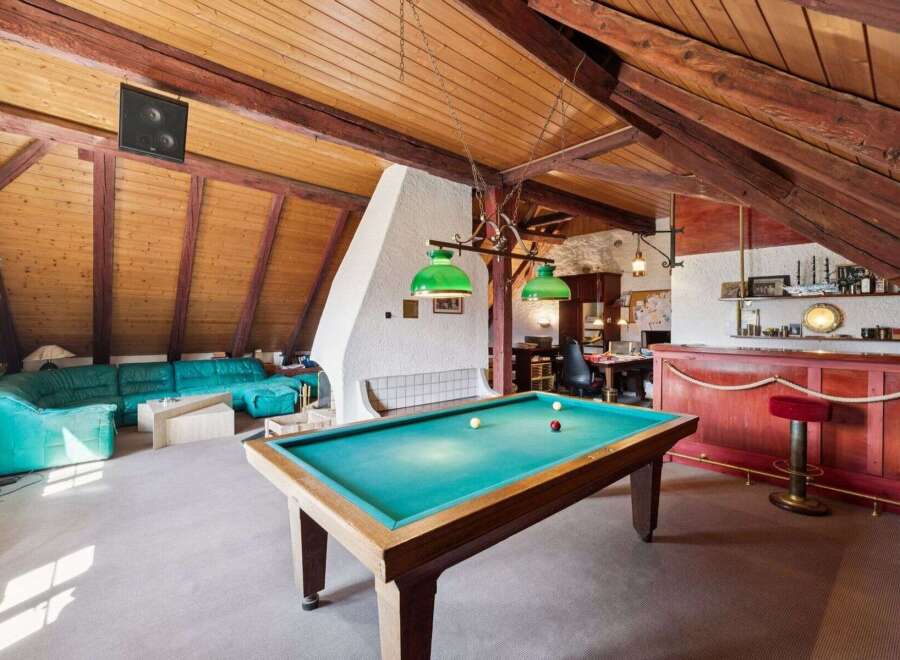 This stunning property features a unique loft-style design with exposed wooden beams and a cozy atmosphere.