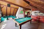 This stunning property features a unique loft-style design with exposed wooden beams and a cozy atmosphere.