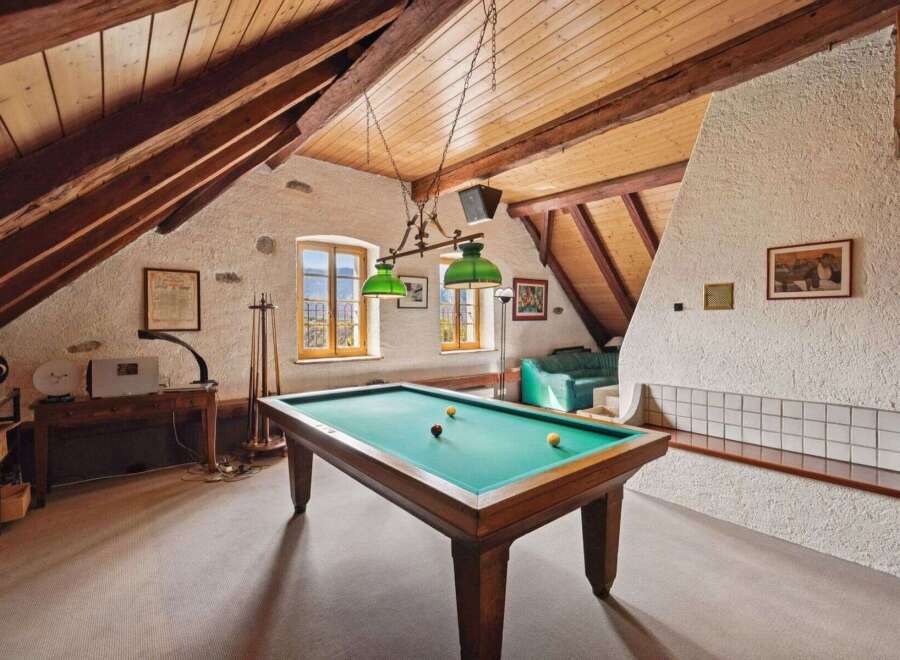This stunning property features a unique game room with a pool table, perfect for entertaining guests.