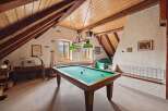 This stunning property features a unique game room with a pool table, perfect for entertaining guests.