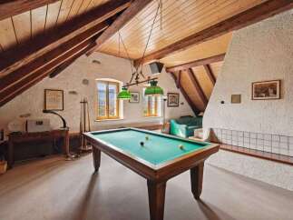 This stunning property features a unique game room with a pool table, perfect for entertaining guests.