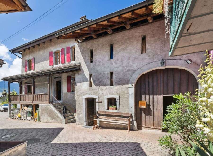Discover the charm of this stunning property, boasting a classic facade and inviting wooden accents.