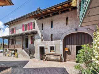 Discover the charm of this stunning property, boasting a classic facade and inviting wooden accents.