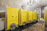 Explore this unique property featuring a wine cellar with multiple yellow fermentation tanks.