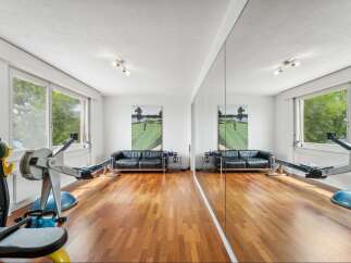 This stunning property boasts a dedicated home gym, perfect for maintaining a healthy lifestyle.