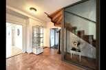 Step into luxury with this stunning property featuring a grand staircase and elegant glass display cases.