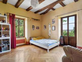 This charming bedroom features a cozy bed, perfect for relaxation.