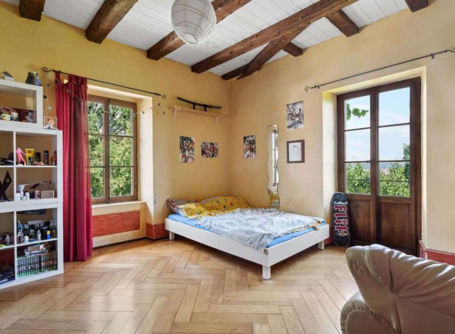 This charming bedroom features a cozy bed, perfect for relaxation.