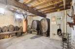 Step back in time with this unique property! This image showcases a rustic wine cellar, complete with wooden barrels and a charming, aged aesthetic.